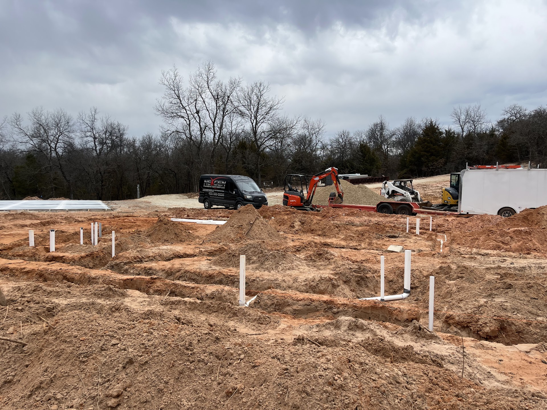 NexGen service van and construction equipment at an underground plumbing jobsite.